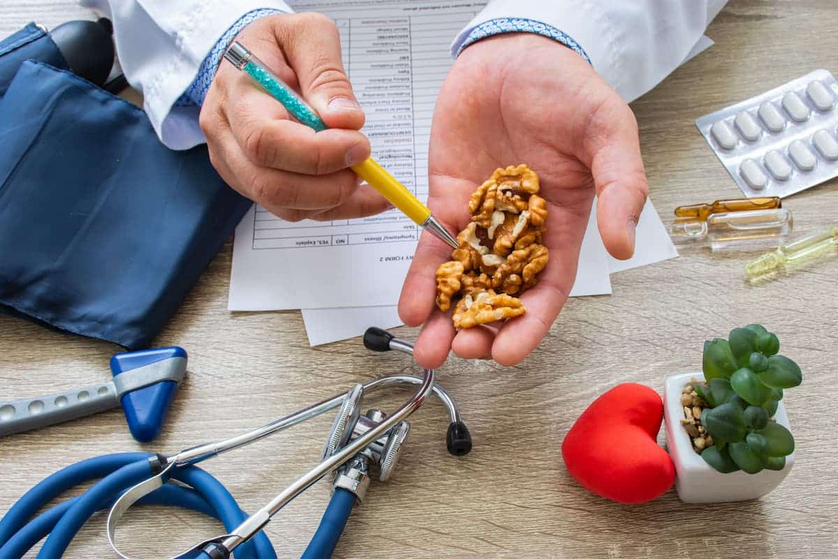 Doctor holding handful of walnuts