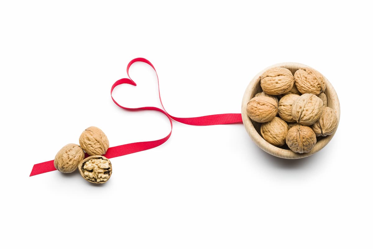 Bowl of walnuts with ribbon in shape of heart