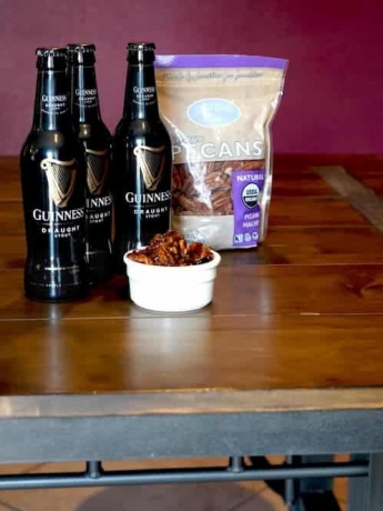 Guinness Beer Pecans surrounded by Guinness Stout bottles and Glenda's Farmhouse Pecans