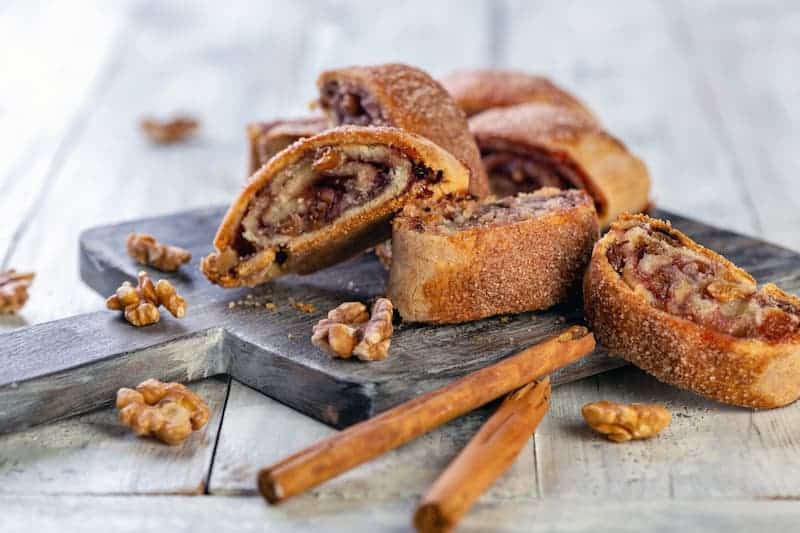 Fresh cinnamon and walnut pastry pinwheels on a cutting board