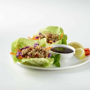 Asian Spiced Walnut Crumbles on butter lettuce with dip, lemon wedges, and hot chilis.