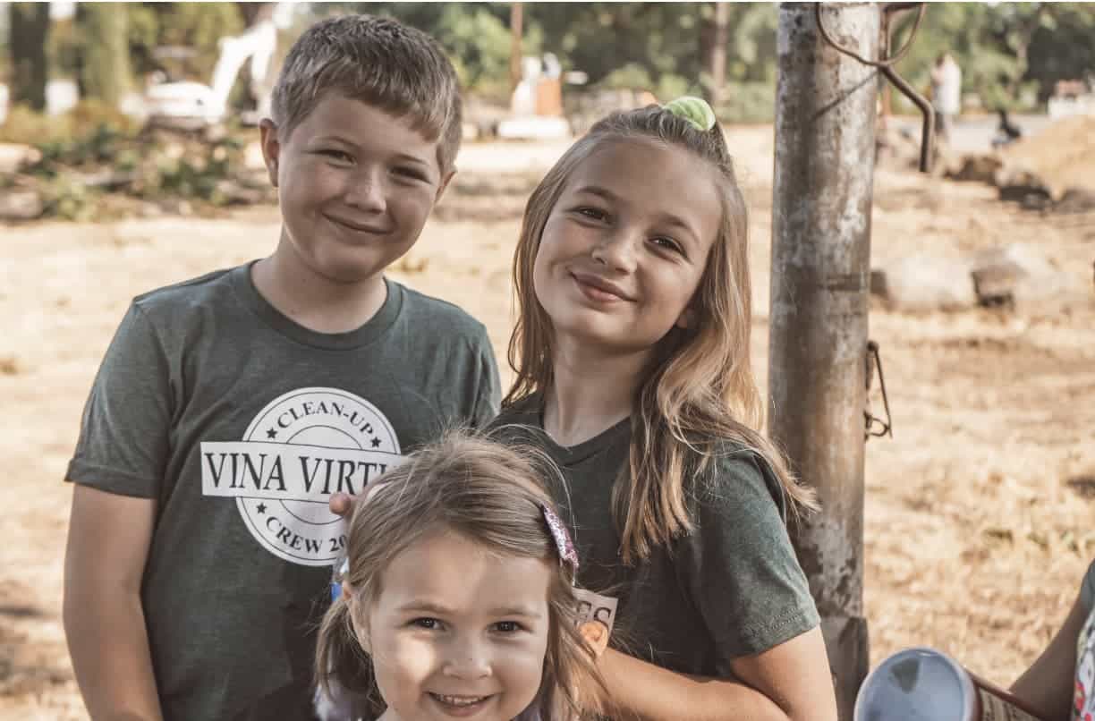 Three children pose for a photo on Glenda's Farm.